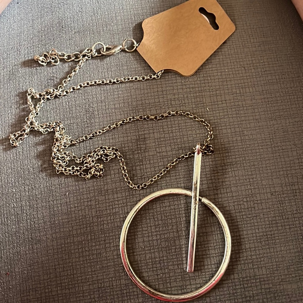 Long Silver color pendant.